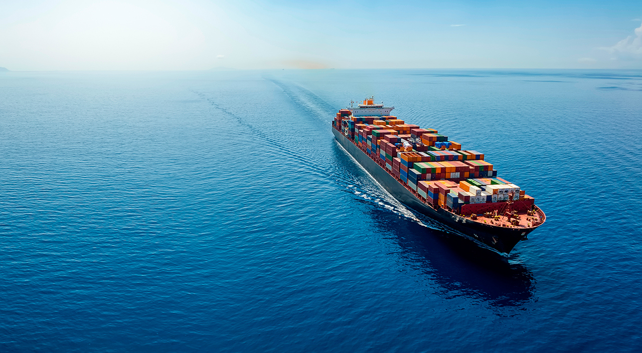 Shipping container from above navigating in open ocean