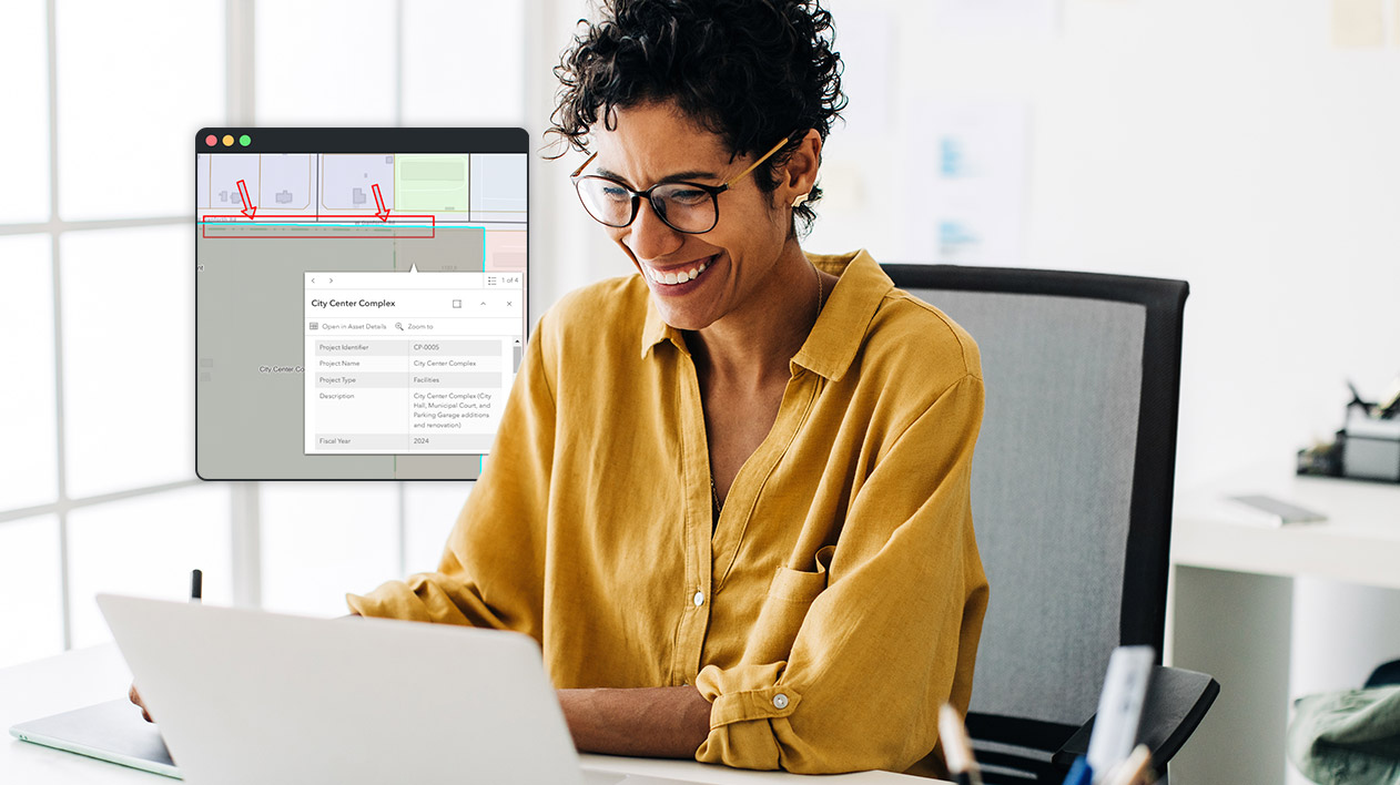 A smiling woman wearing a yellow shirt and glasses is looking at a laptop, with a software interface showing project details for a "City Center Complex" overlaid on the screen